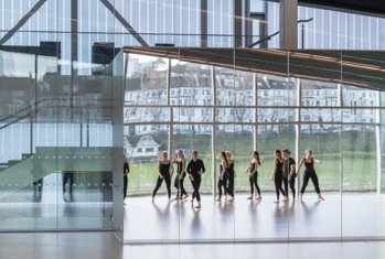 Reflection in the mirror of dancers rehearsing in the Patten Studio in the SSS