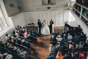 Bride and Groom saying their vows infront of the congregation in the Hordern Room