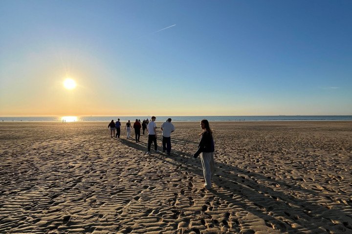  Pupils on a French, Art and Photography trip to Northern France enjoying the sunset on the beach 