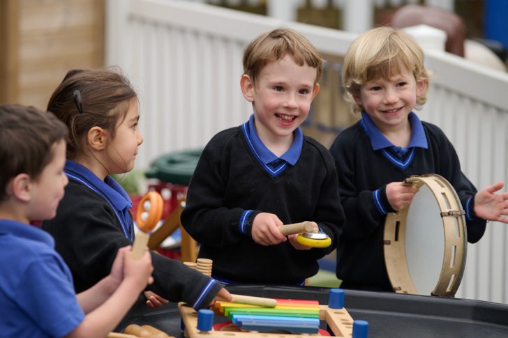  Pre-Prep pupils in the playground playing musical instruments 