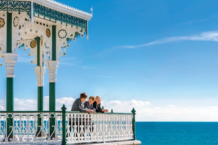  Pupils enjoying themselves on the Bandstand in front of the beach 