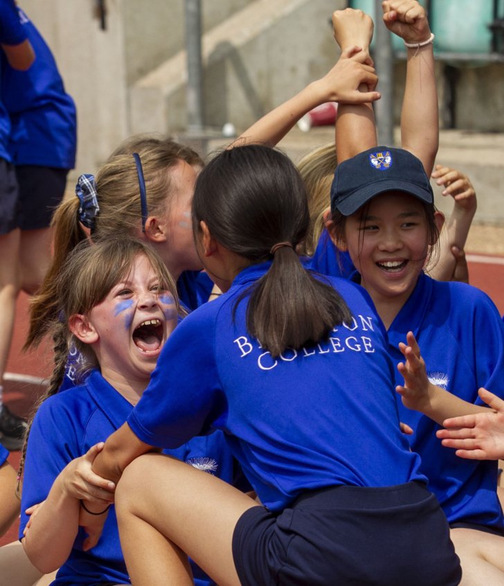  Prep School pupils celebrating with their house teammates on Sports Day 