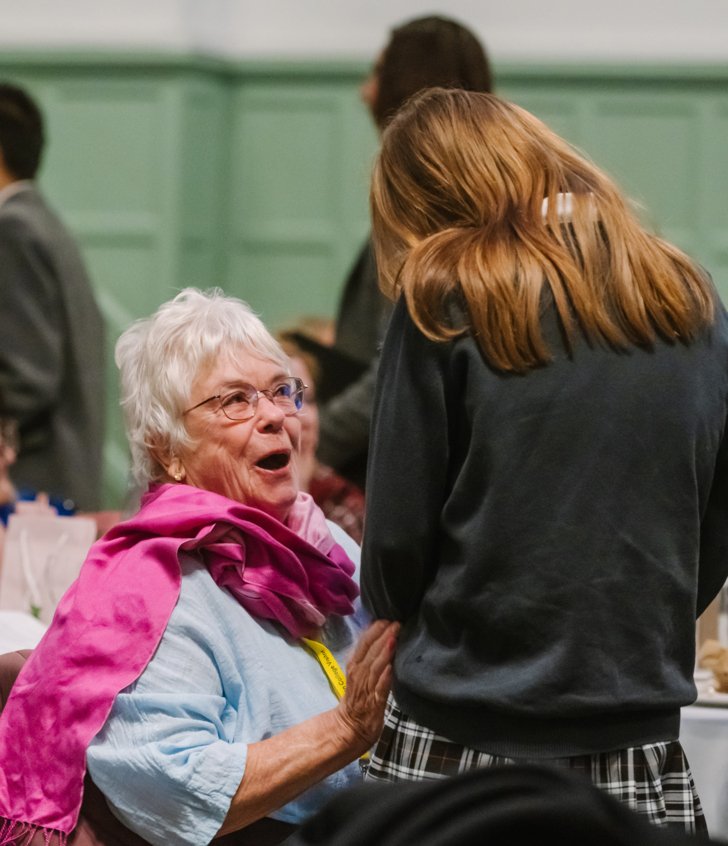  Pupils hosting a tea for the elderly members of the local community in the Great Hall 