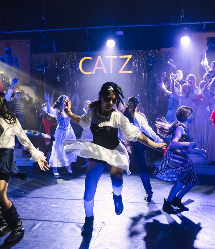  Lower School pupils on stage performing a number in their production of Catz 