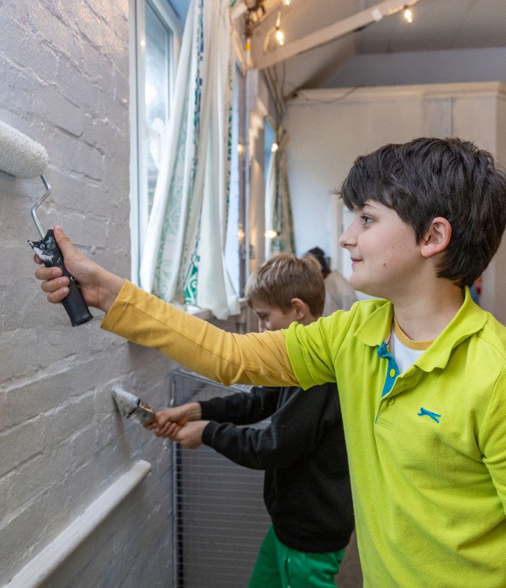  Prep School pupils painting walls in the local community as part of Make A Difference Day 