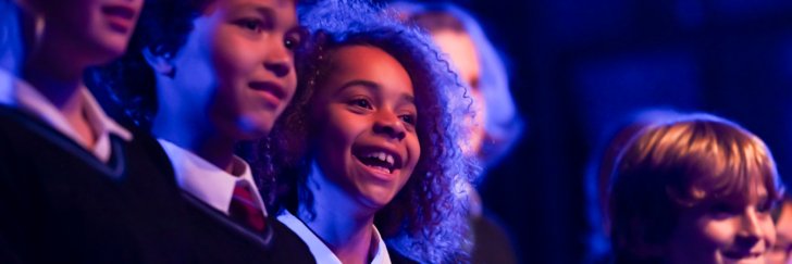  Prep-School pupils under the spotlight performing a concert on the stage 