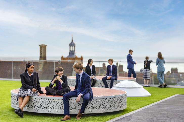  Sixth Form pupils talking to younger pupils in the Sky Garden on the roof of SSS 