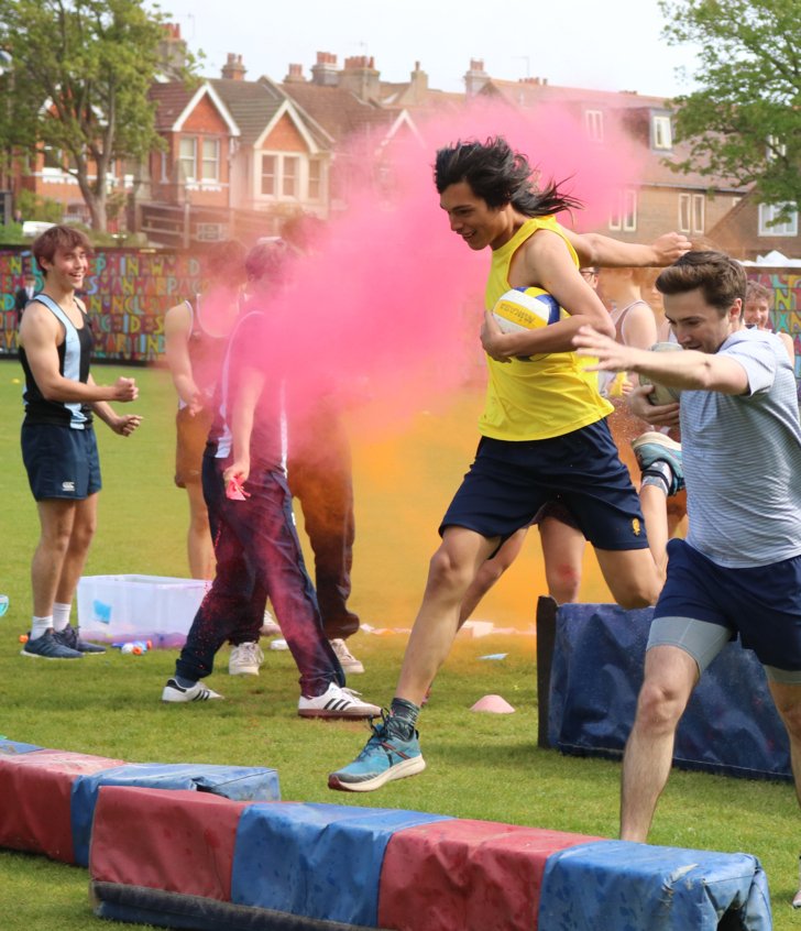  Pupils and staff completing the obstacle cause holding balls in order to raise money for OddBalls 