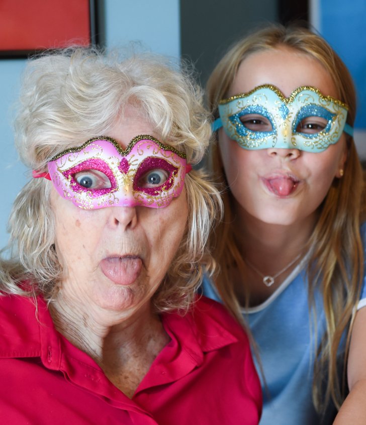  Pupil and a woman from a local Care Home enjoying dressing up and spending time together 