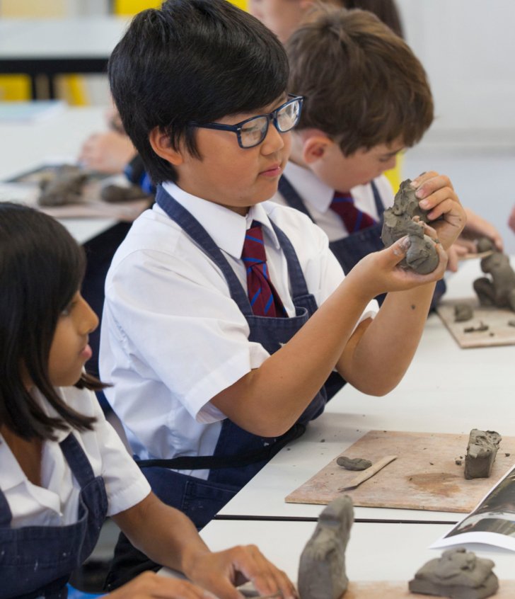  Prep School pupil making a model out of clay in Art 