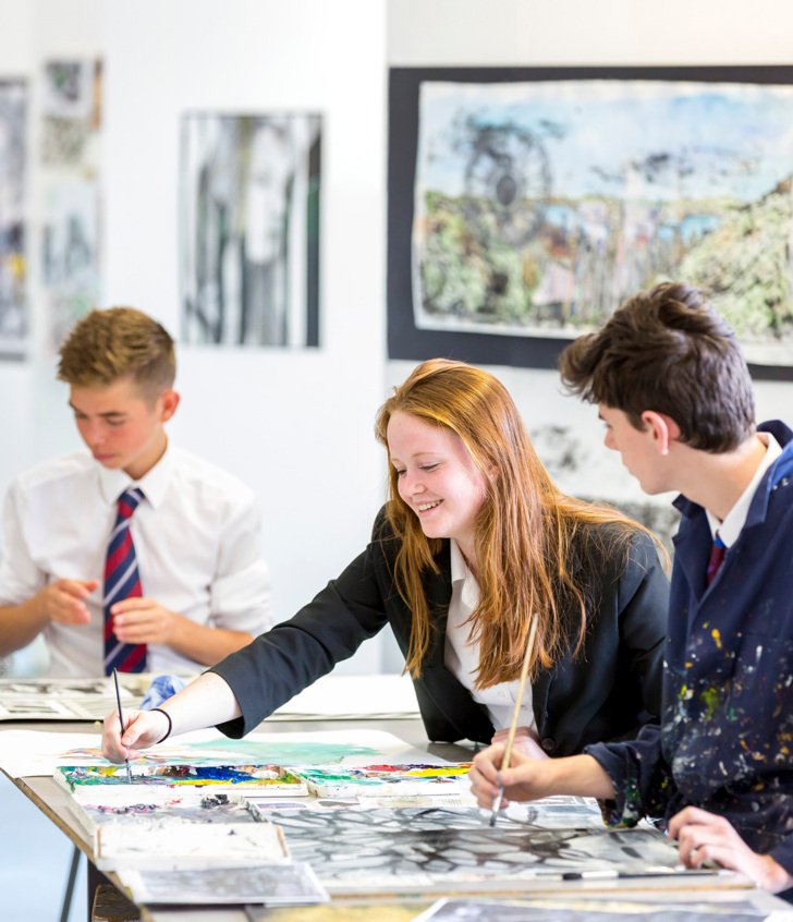  GCSE Art pupils in the Art Room enjoying talking whilst working on their coursework pieces 