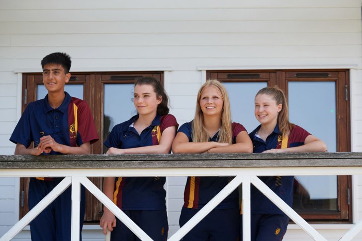  Pupils in Cricket kit standing outside the Sammy Woods pavilion 