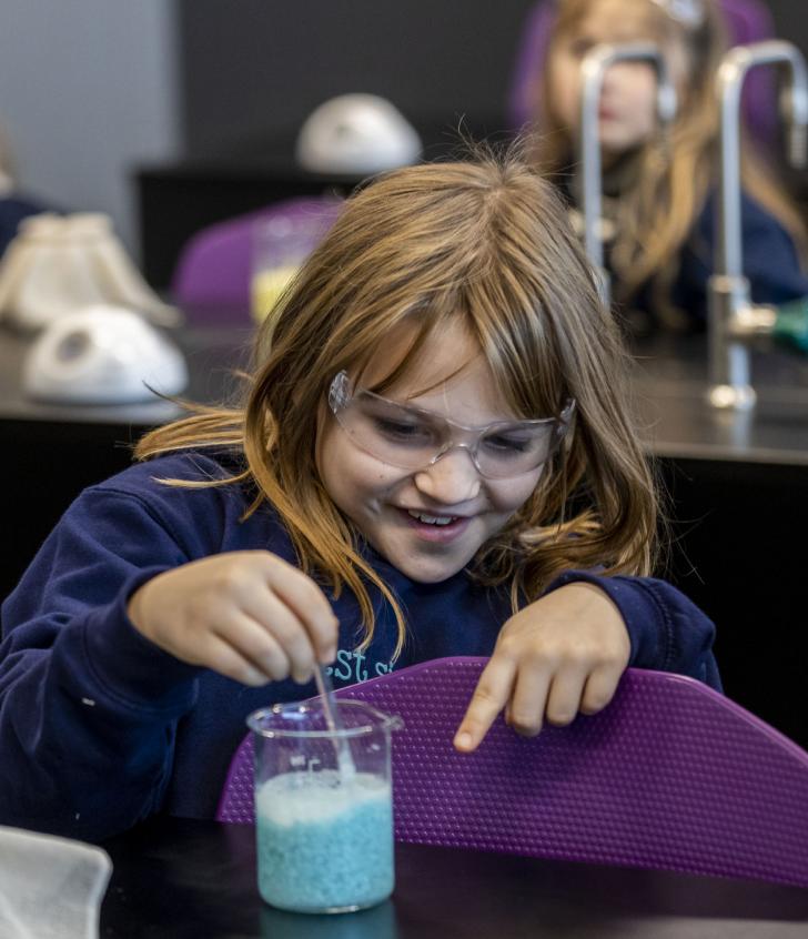  Prep School pupils making slime in a beaker in a Science lab at Rockhoppers 