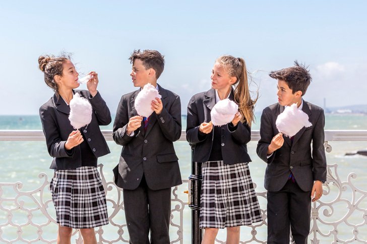  Pupils enjoying eating candy floss on Brighton Pier 