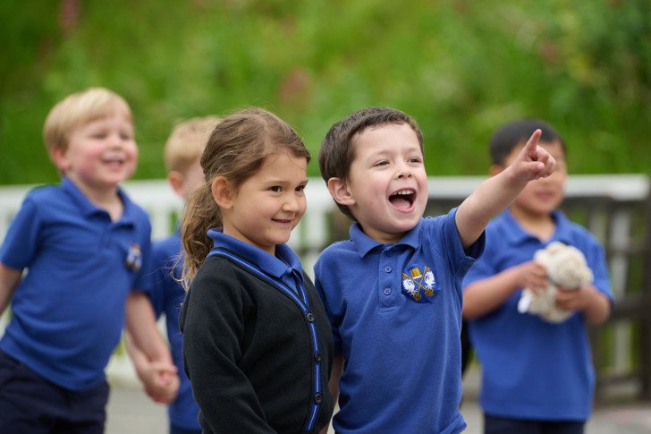  Nursery pupils in uniform having fun playing together 