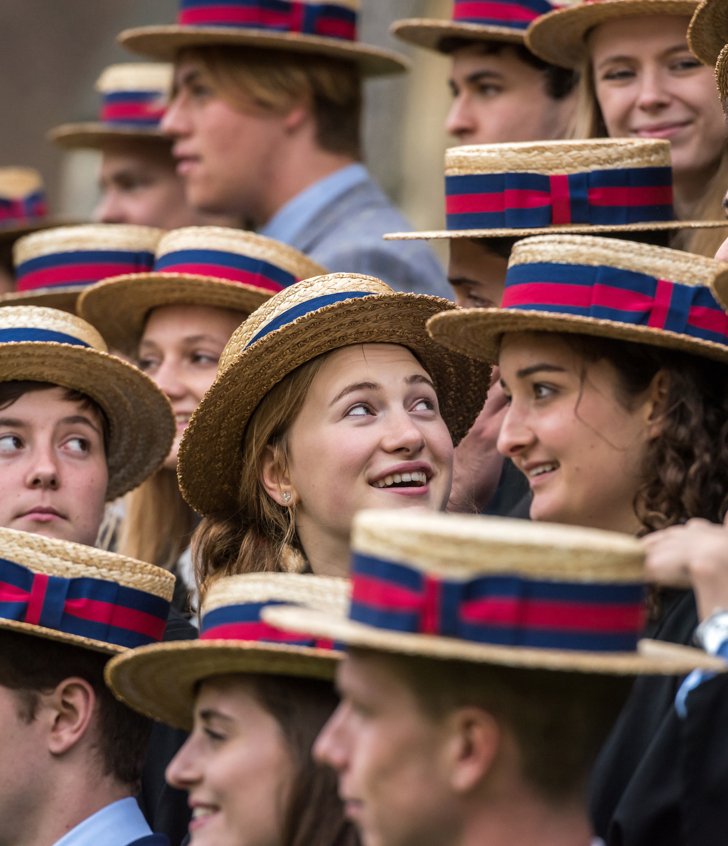  Upper Sixth pupils in suits and boaters standing together for a photograph 