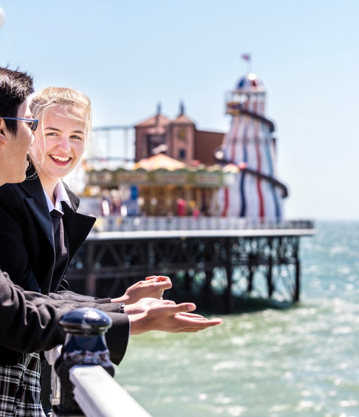  Pupils on a sunny day enjoying chatting on the Pier looking out at the view of the sea 