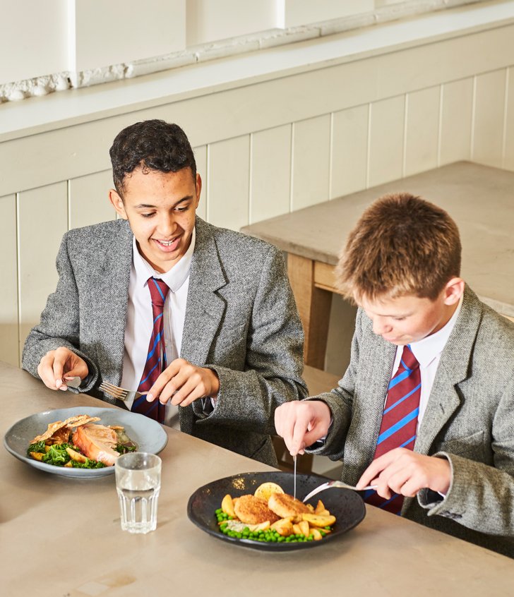  Pupils in the Dining Room eating fish and chips and roast pork and enjoying talking to each other over their lunch 