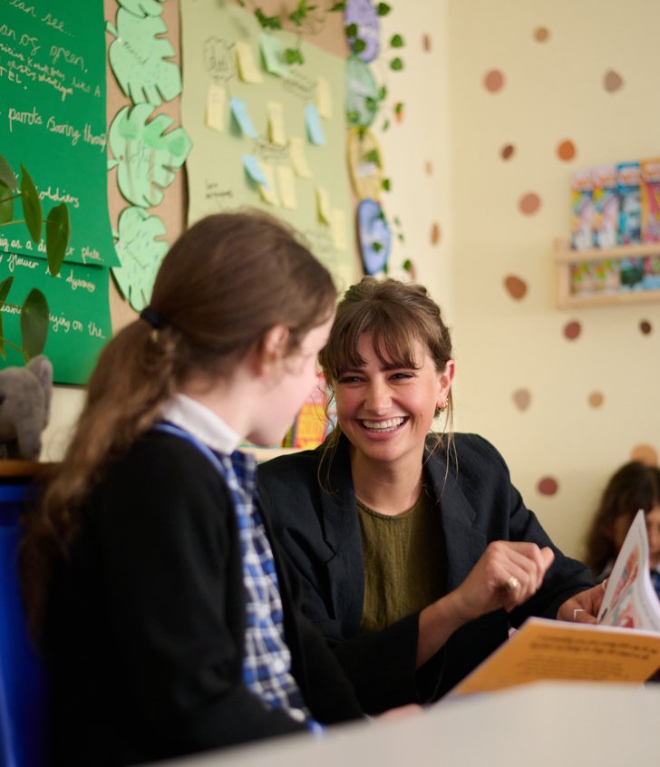  Pre-Prep pupil in a classroom reading together with a teacher 