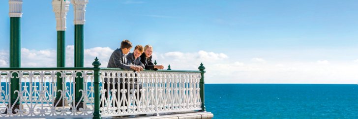  Sixth Form pupils enjoying themselves on the Bandstand in front of the beach 