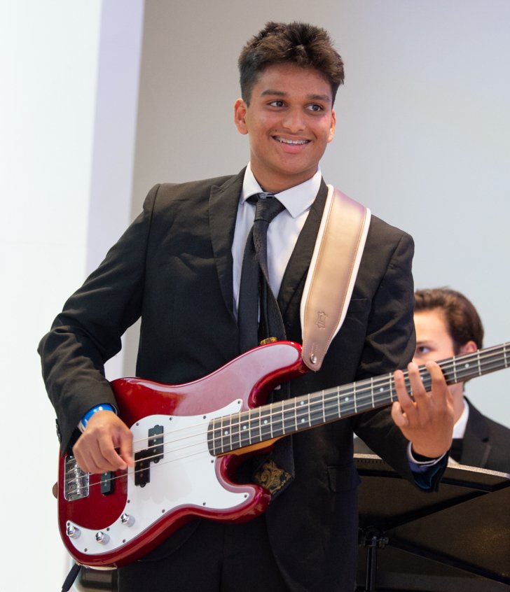  Pupil enjoying playing the electric guitar as part of a concert in the Sarah Abraham Recital Hall 