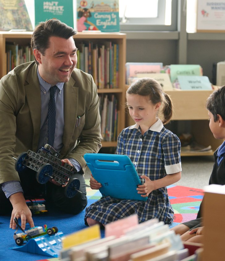  Pre-Prep pupils and a teacher enjoying learning coding with electronics in the classroom 