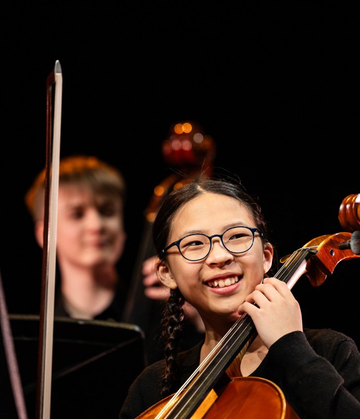  Music pupils enjoying performing a piece on the cello and double bass 