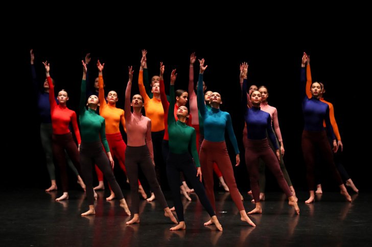  Sixth Form dancers on the stage in different coloured outfits 