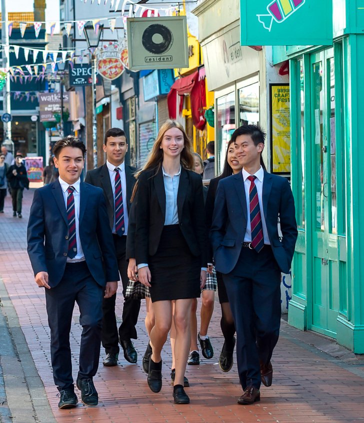  Pupils in their uniform and suits walking through the Brighton Laines together 