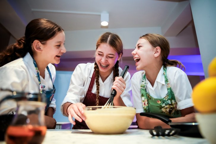  Boarding pupils enjoying baking together in the kitchen 