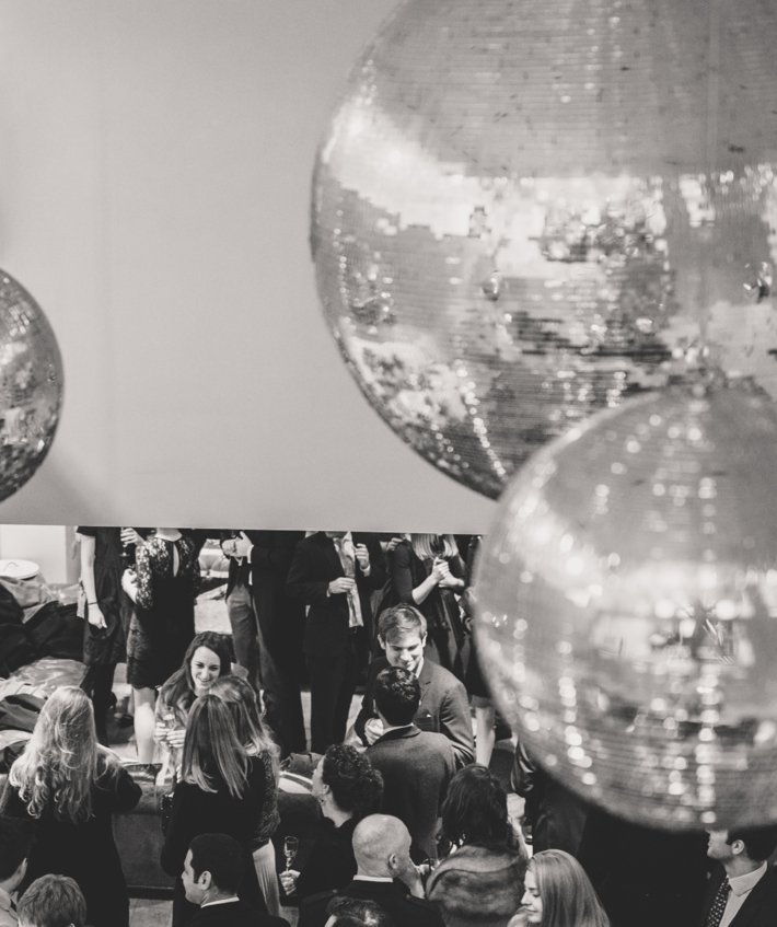  Guests enjoying an event celebrated in the Smith Café under the disco balls 