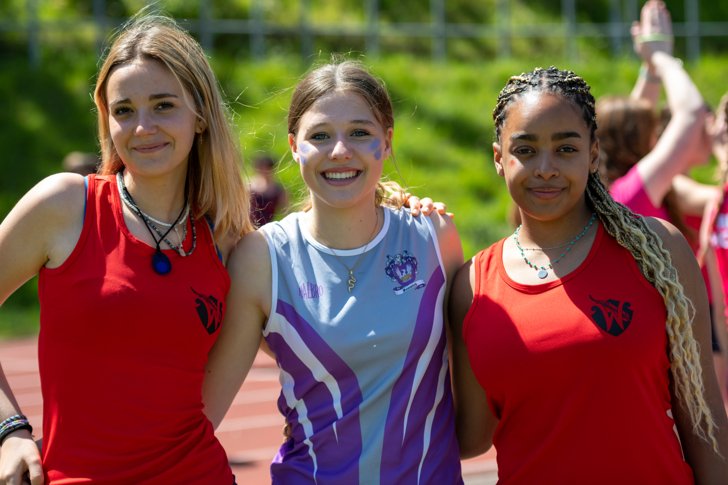  Williams pupils with their arms around a Fenwick pupil in athletics vests on Sports Day 