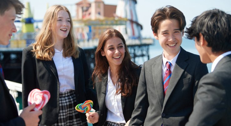  Pupils enjoying lollipops on the seafront in front of the Pier 