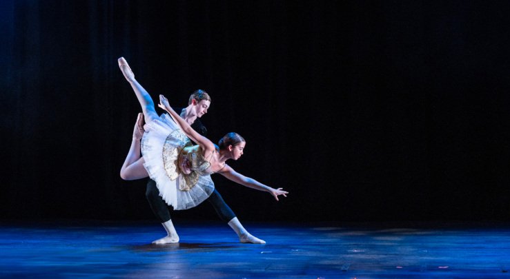  Dancer lifting other dancer in their ballet duet performance on stage 