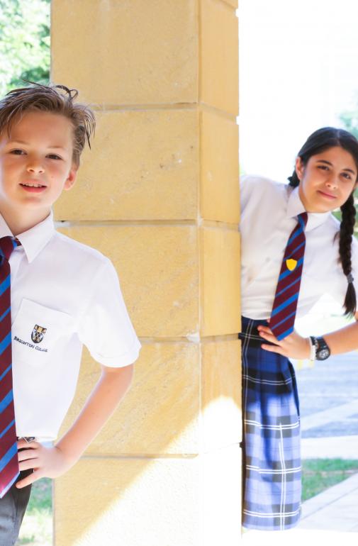  Pupils in uniform popping out from behind pillars at Brighton College Abu Dhabi 