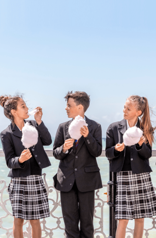  Pupils enjoying eating candy floss on Brighton Pier 