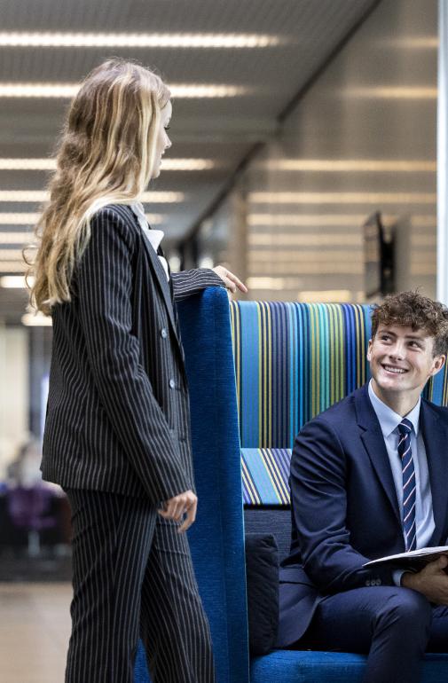  Pupils sitting and standing around the seats in the SSS enjoying talking 