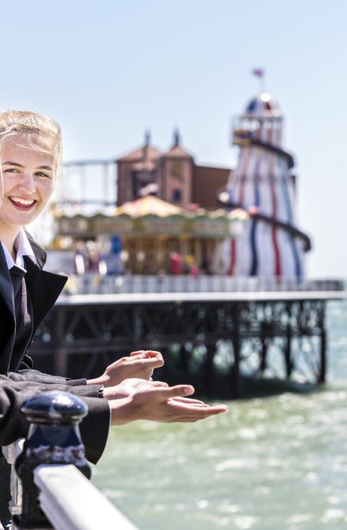  Pupils on a sunny day enjoying chatting on the Pier looking out at the view of the sea 