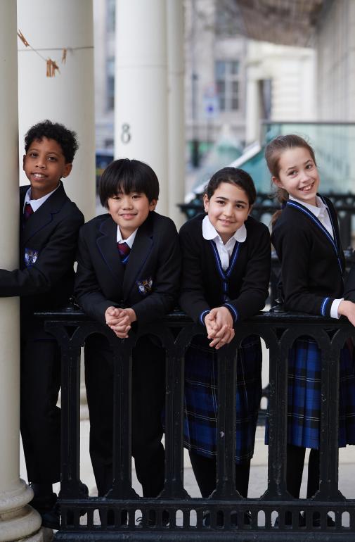  Pupils in their uniform outside the doors of Brighton College Kensington 